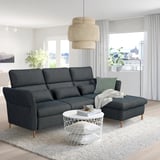 Modern living room with dark grey FAMMARP 3-seat sofa, white coffee table, and large window. Sofa adjustable headrests and armrests.