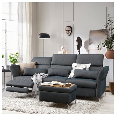 A modern, dark grey FAMMARP sectional sofa with adjustable headrests and armrests, positioned on a speckled rug.