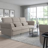 Modern living room with gray FAMMARP sofa, armchair, glass table, art, and large windows.