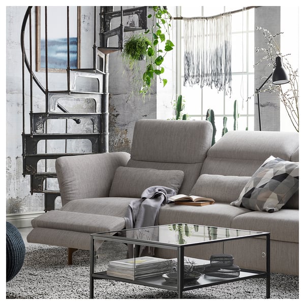 Modern grey FAMMARP sofa set with adjustable headrests, glass coffee table, and spiral staircase.