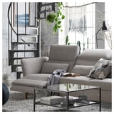 Modern grey FAMMARP sofa set with adjustable headrests, glass coffee table, and spiral staircase.