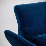 Blue velvet sofa detail, showcasing luxurious fabric & comfort-focused design.