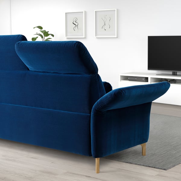 Blue FAMMARP sofa with wooden legs, adjustable head & armrests, large & comfortable in minimalist living room.