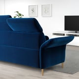 Blue FAMMARP sofa with wooden legs, adjustable head & armrests, large & comfortable in minimalist living room.