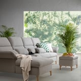 Living room with FAMMARP sofa, green pillows, white throw, and footstool with fruits near window showcasing greenery.
