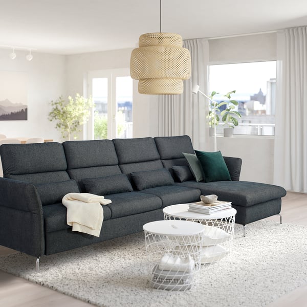 Modern living room: dark gray FAMMARP sectional sofa, white coffee tables, large window, pendant lamp.