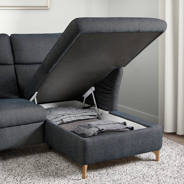 Modern sofa with lift-up seat for storage, adjustable headrests, and wooden legs.
