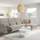 Modern living room with gray FAMMARP sofa, woven pendant lamp, and white coffee tables, creating a cozy atmosphere.