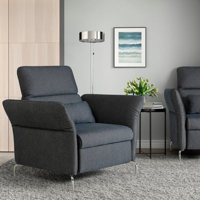 Modern living room with two grey FAMMARP armchairs, silver floor lamp, decorative art, and vase. Armchairs are large with metal legs and adjustable.