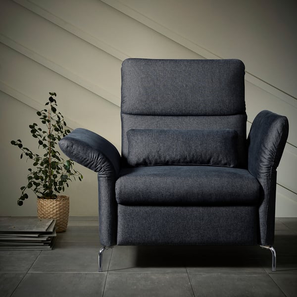 Modern blue FAMMARP accent chair with adjustable headrest and arms, a plush seat, metal legs, and structured back, set against a pale wall.