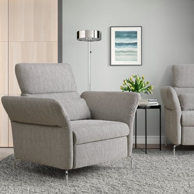 Modern gray FAMMARP armchair in living room with chrome legs, cushioned seating, painting, plant.