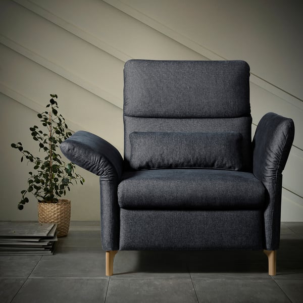 Dark blue FAMMARP armchair with wooden legs, textured fabric, adjustable armrests, set against a plain wall.