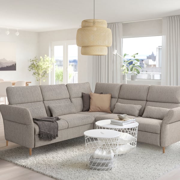 Modern living room: large grey FAMMARP sofa, white coffee table, round lampshade, big windows, city view.