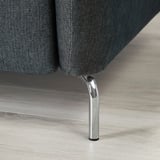 Dark gray sofa with sleek, curved chrome legs, highlighting modern design and quality craftsmanship.