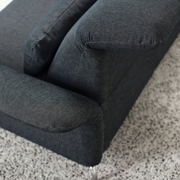 Close-up of dark grey FAMMARP sofa, showcasing plush, inviting cushions and meticulous stitching, emphasizing comfort and quality.