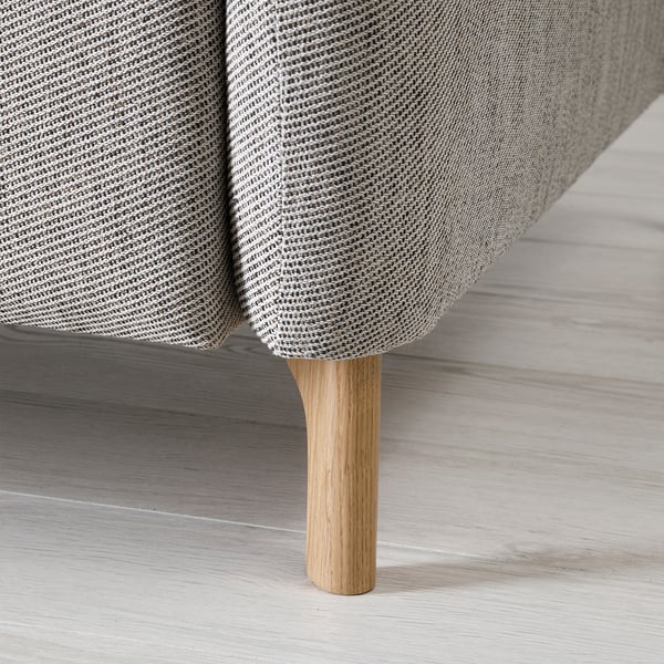 A modern sofa with a light grey, textured fabric and wooden legs, emphasizing comfort and quality.