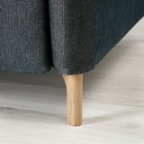 Modern sofa with adjustable headrests and wooden legs, designed for comfort and durability.