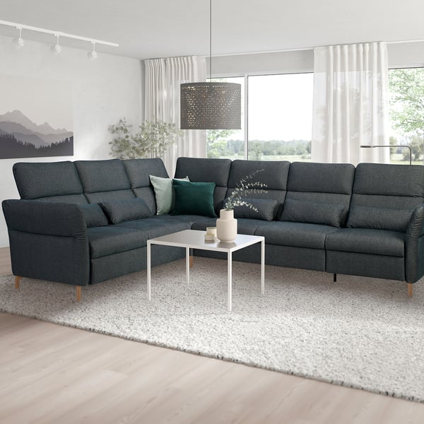 L-shape FAMMARP sofa, coffee table, large windows, area rug.