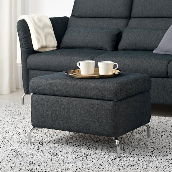 Modern living room with FAMMARP footstool, sofa, and two cups on tray.