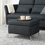 Modern living room with FAMMARP footstool, sofa, and two cups on tray.
