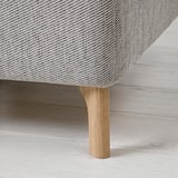 Modern sofa with chic wooden legs, upholstered in textured fabric. Blends comfort and style.