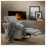 Cozy living room with gray FAMMARP recliner by fireplace, cushioned for comfort, paired with textured rug and modern decor.