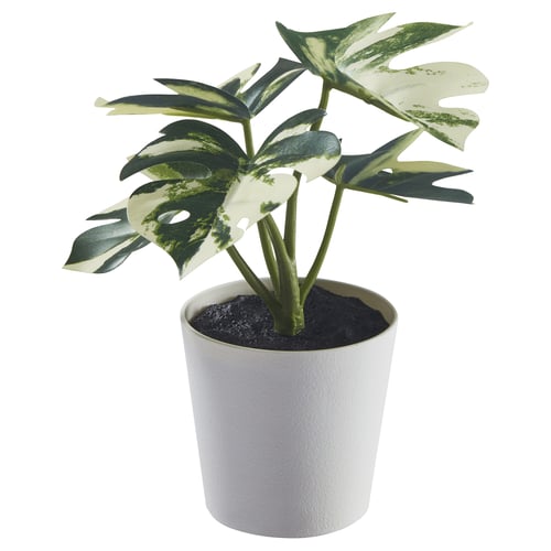 White potted plant with green leaves, fake, made from recycled materials.