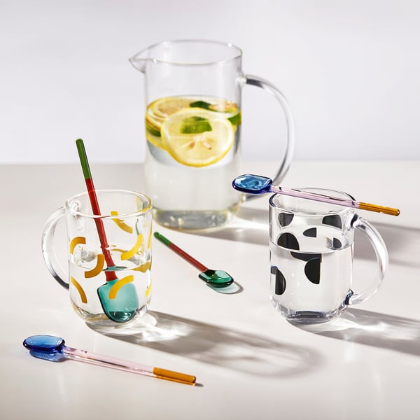 Colorful glass spoons beside drinks, adding vibrancy and versatility.