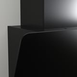 Black modern range hood angled sleek, mounted on wall.