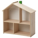 Wooden light-colored house-shaped shelf with single green block on top.