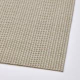 Woven beige plastic place mat, rectangular, textured grid pattern, lays flat.