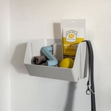 Wall-mounted pet organizer with dog food, leash, and toys.