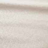 Soft, patterned roller blind in beige, featuring subtle circular designs, effective light blockage, smooth operation.