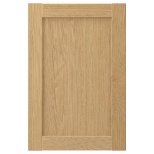 Image shows a single light oak FORSBACKA cabinet door with a classic beveled frame design.