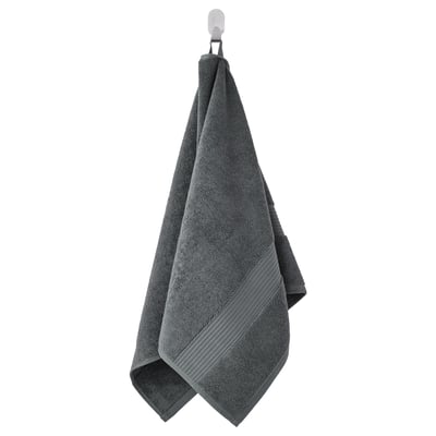 A hanging dark gray FREDRIKSJÖN towel, made of soft cotton, with a textured surface and a decorative woven border.