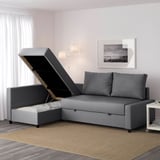 Modern gray sectional sofa with storage chaise, open lid revealing storage space.