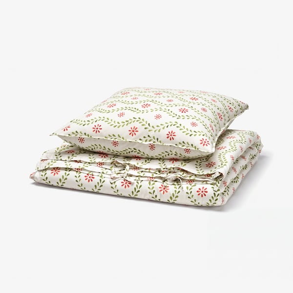 Folded FYRISVIDE duvet set, white with red and green floral pattern, soft cotton, rectangular.