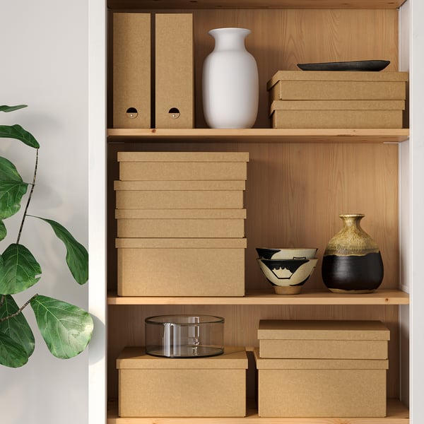 Wooden shelves storing cardboard boxes and decorative items, including vases and bowls.