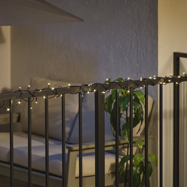 Balcony railing with warm white led lights, creating festive mood. The lights turn on at dusk and off at dawn automatically.