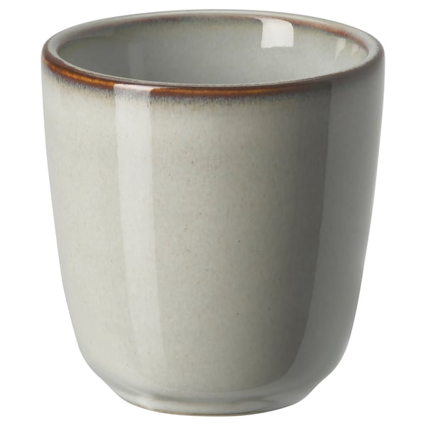 Glazed ceramic mug, sand color, round shape with rustic edges, part of the GLADELIG series.