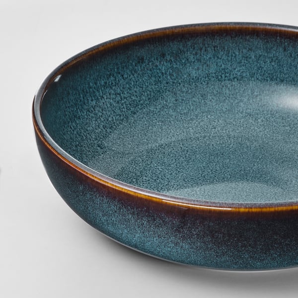 Blue-green glazed dish with gold trim.
