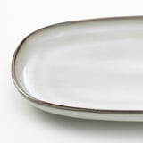 Oval, glazed stoneware serving dish. High-quality, perfect for table settings.