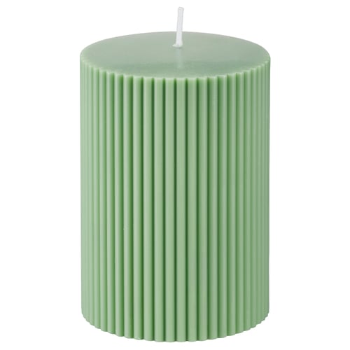 Green cylindrical candle; ribbed design; wax blend; cotton wick; decorative home accent.