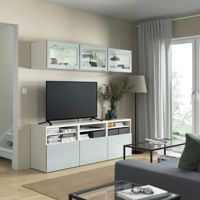 Modern living room with GLASSVIK glass cabinet and selsvik tv stand. Minimalist design with decor, lamp, and coffee table.