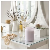 Lavender candle on glass table with decor