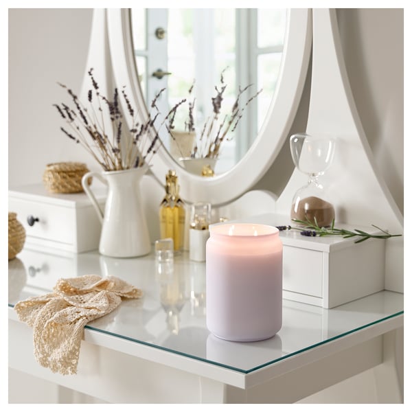 Vanity display: lavender candle, dried flowers, mirror.