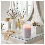 Vanity display: lavender candle, dried flowers, mirror.