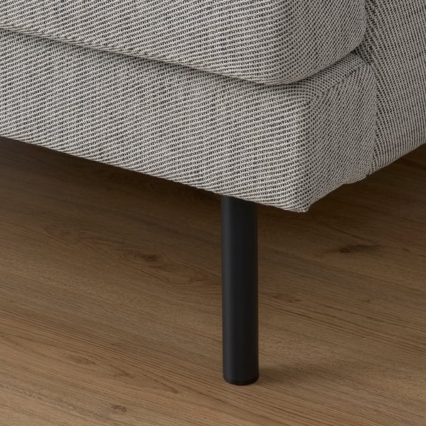Modern sofa with plush cushions on wooden floor, black metal leg visible. High-quality, inviting design.