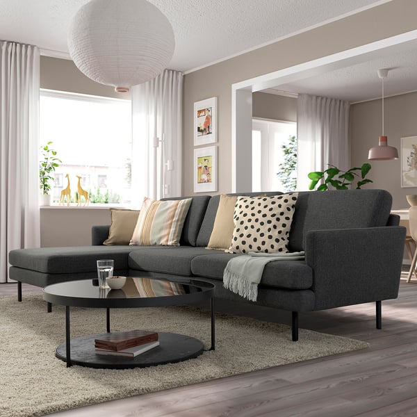 Modern living room with GRILLSTORP grey sectional, black accents, and large windows.