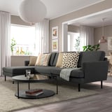 Modern living room with GRILLSTORP grey sectional, black accents, and large windows.